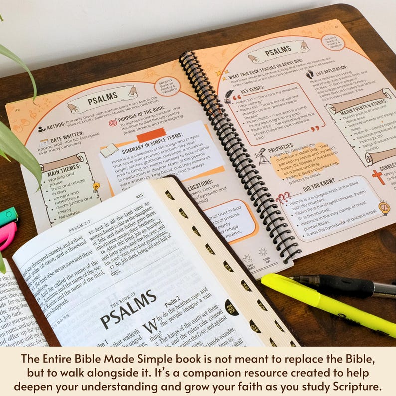 May include: Open Bible study guide with the title "Psalms" and detailed notes. The spiral-bound book is open to reveal colorful diagrams, key verses, and summaries. A highlighter and pen rest on the pages, alongside a separate bookmarked section.