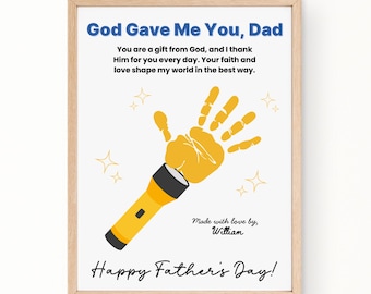 May include: A framed print with the text "God Gave Me You, Dad" in blue. The image features a yellow handprint with a flashlight, and the words "Happy Father's Day!"