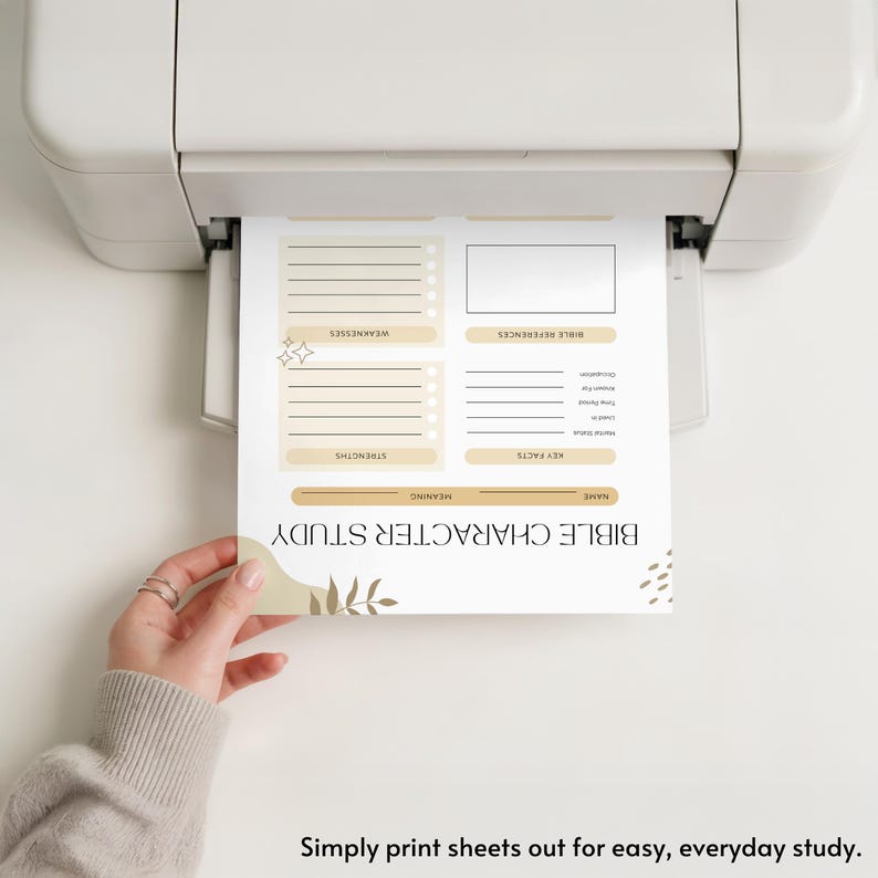 May include: A printer is shown printing a beige and white Bible Character Study sheet. The sheet includes sections for weaknesses, strengths, key facts, and Bible references. The text "Simply print sheets out for easy, everyday study" is at the bottom.
