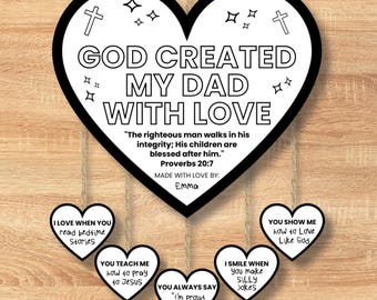 May include: A black and white heart-shaped sign with the text "GOD CREATED MY DAD WITH LOVE." Additional heart-shaped tags read "I LOVE WHEN YOU read bedtime stories," "YOU TEACH ME how to pray to Jesus," and more. The sign includes a Bible verse.