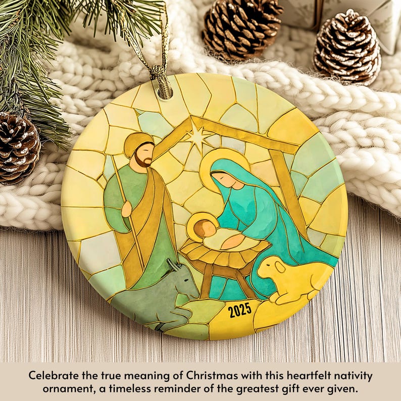 May include: Round Christmas ornament featuring a nativity scene with Joseph, Mary, and baby Jesus. The ornament has a stained-glass style design with a star, donkey, and sheep. The year "2025" is printed on the ornament.