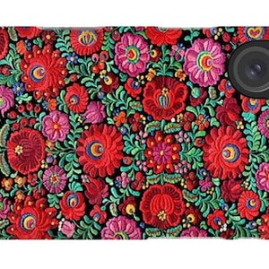 May include: A smartphone case featuring a dense, vibrant floral pattern on a black background. The design consists of intricate red, pink, and purple flowers interspersed with detailed green foliage and small blue accents, covering the entire surface.