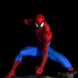 May include: A red and blue action figure of Spider-Man in a dynamic pose, standing on a rocky base. The figure is detailed with a web pattern and has a classic Spider-Man mask.