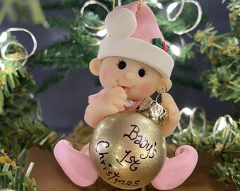 Baby's 1st Christmas Ornament Personalized little baby dressed in pink holding gold ornament