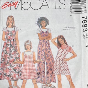 May include: A vintage McCall's sewing pattern envelope. The front features illustrations of four different sundress and jumpsuit designs. The envelope is white with the text "Easy McCall's" in red. The pattern number is 7693, size 14.