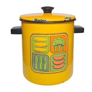 May include: A bright yellow enamel stockpot with a matching lid and two black side handles. The front features a square graphic divided into four sections displaying illustrations of corn, broccoli, asparagus, and sausages in vibrant colors.