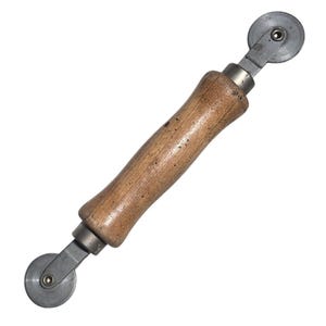 May include: A vintage screen rolling tool with a wooden handle and two small metal wheels. The handle is a light brown color, and the metal components are silver. This tool is used for installing or repairing window screens.