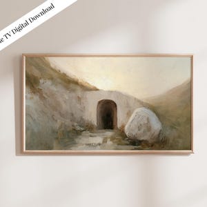 Puede incluir: Descarga digital de una pintura de paisaje en un marco de madera. La obra representa una entrada de túnel en una ladera, con una gran roca blanca a la derecha. La paleta de colores es apagada, con tonos beige, marrón y blanco. El texto "Samsung Frame TV Digital Download" está en la esquina superior izquierda.