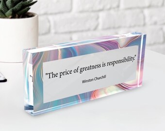 May include: A rectangular acrylic block with a swirling, iridescent design in shades of blue, purple, and pink. The block features a white rectangular panel with the quote "The price of greatness is responsibility." by Winston Churchill.