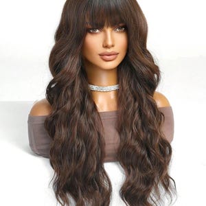 A mannequin head with long, wavy brown hair styled in a side part and bangs. The mannequin is wearing a necklace.