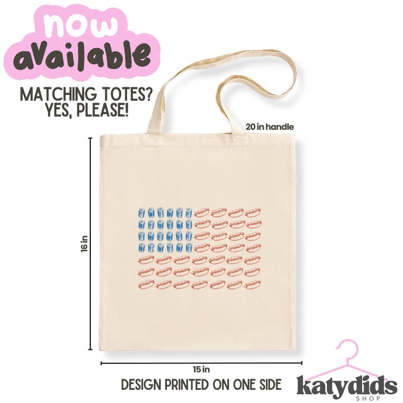 May include: A cream-colored tote bag with a design resembling the American flag, featuring blue drink glasses and red hot dogs. The bag is 16 inches tall and 15 inches wide, with a 20-inch handle. Text on the bag says "MATCHING TOTES? YES, PLEASE!" and "DESIGN PRINTED ON ONE SIDE."