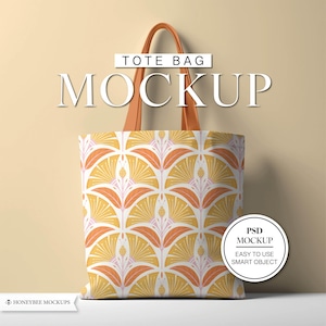 May include: A tote bag mockup with a repeating floral pattern in yellow, orange, and pink. The bag has brown leather handles and the text "TOTE BAG MOCKUP" is displayed above it. A circular graphic reads "PSD MOCKUP EASY TO USE SMART OBJECT".