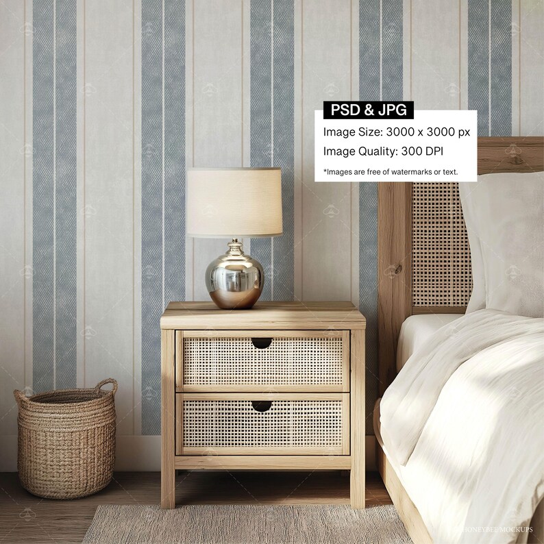 May include: A wooden nightstand with two drawers featuring a woven rattan front. The nightstand has a white lamp with a silver shade and a woven basket on the floor next to it. The nightstand is in front of a bed with a white headboard and white bedding.