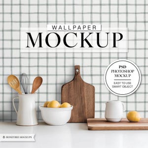May include: A mockup of a kitchen wallpaper with a gray and white plaid pattern. The wallpaper is shown in a kitchen setting with a cutting board, a pitcher, a bowl of lemons, and a mug. The text "WALLPAPER MOCKUP" is displayed at the top of the image. The text "PSD PHOTOSHOP MOCKUP" is displayed in a circle at the bottom right of the image. The text "EASY TO USE SMART OBJECT" is displayed below the circle.