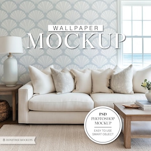 May include: A white sofa with three pillows sits in front of a light blue wallpaper with a seashell pattern. The wallpaper has the text "WALLPAPER MOCKUP" on it. A wooden coffee table with a stack of books sits in front of the sofa. A white circle with the text "PSD PHOTOSHOP MOCKUP EASY TO USE SMART OBJECT" is in the lower right corner of the image.