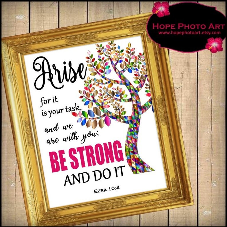 May include: A framed inspirational quote with a colorful tree design. The quote reads "Arise for it is your task, and we are with you, Be Strong and Do It." The quote is attributed to Ezra 10:4.