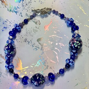 161/2 Choker made with stainless steel, lapis lazuli, torch fired beads. Cobalt blue and lavender tones. Metal leaf clasp image 7