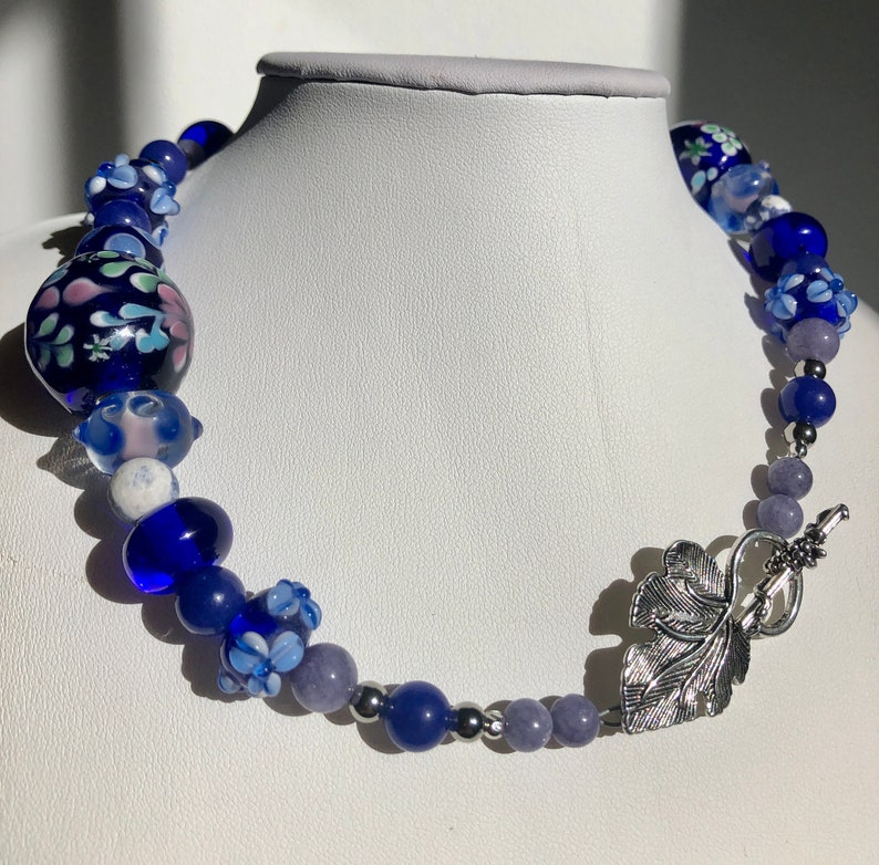 161/2 Choker made with stainless steel, lapis lazuli, torch fired beads. Cobalt blue and lavender tones. Metal leaf clasp image 1