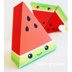 May include: Triangular watermelon-shaped paper boxes with smiling faces and black seed details. The boxes are red with green and yellow stripes at the base. The boxes are decorated with a cute cartoon watermelon design.