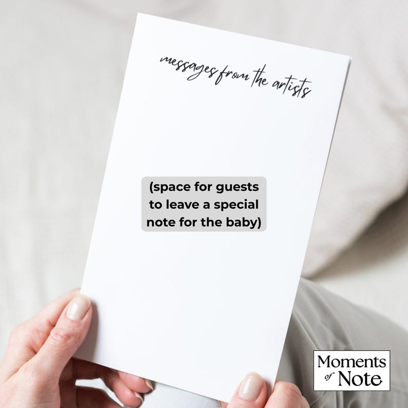 May include: A white card with the text "messages from the artists" and "(space for guests to leave a special note for the baby)". The card is held by a person. The Moments of Note logo is in the bottom right corner.