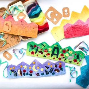 May include: A collection of craft supplies for making felt crowns. The image shows several finished crowns with embroidered designs of flowers, animals, and celestial elements. Also included are felt sheets, stencils, and colorful ribbons.