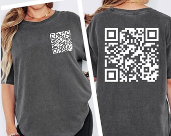 May include: Dark gray t-shirt with a white QR code on the front and back. The shirt has short sleeves and a crew neck. The QR code is a square matrix barcode.