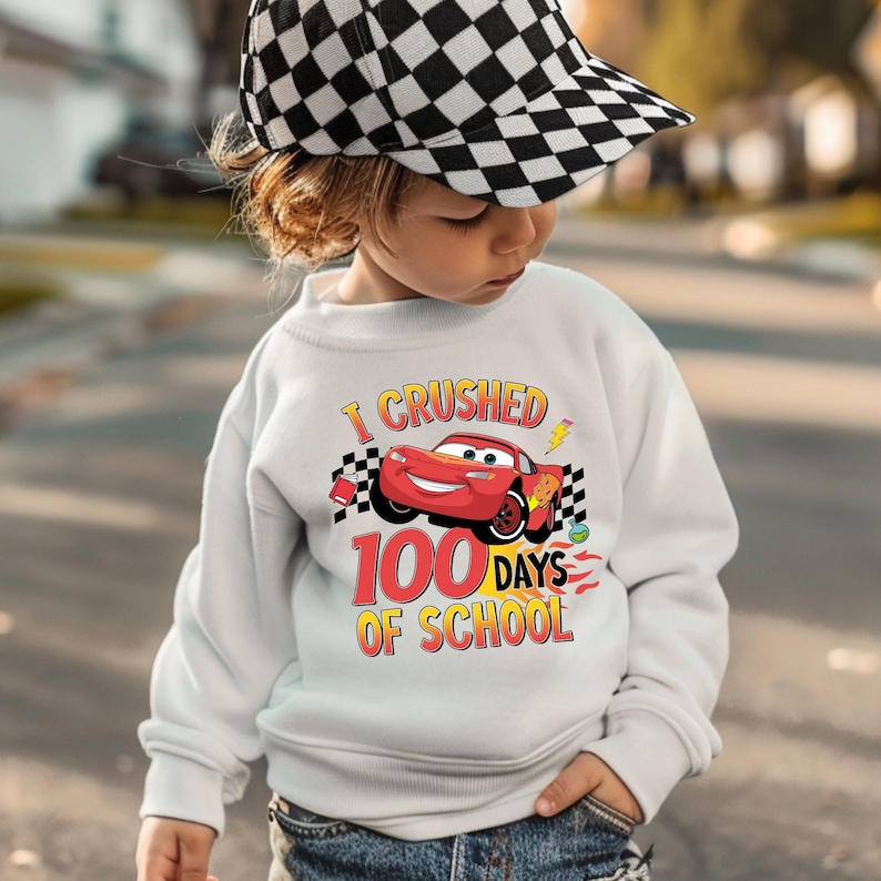 a young child wearing a white sweatshirt and a checkered hat