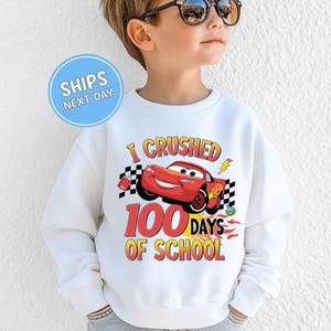 a young boy wearing a sweatshirt that says i crushed 100 days of school