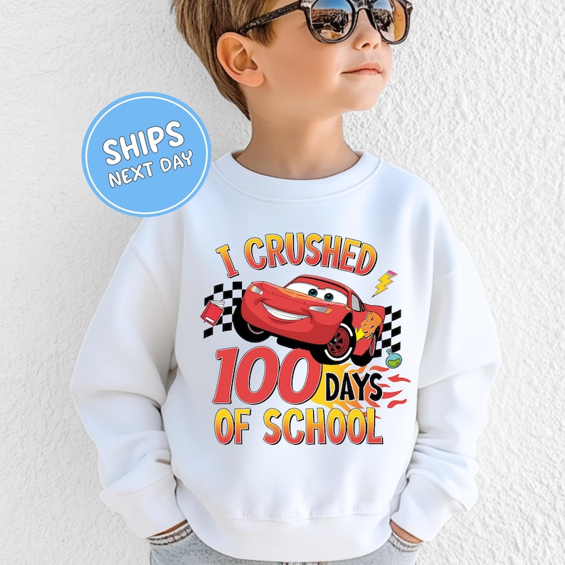 a young boy wearing a sweatshirt that says i crushed 100 days of school