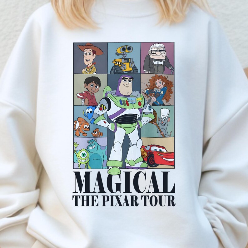 A white sweatshirt with a graphic design featuring characters from the animated film "Pixar's Magical The P Pixar Tour".