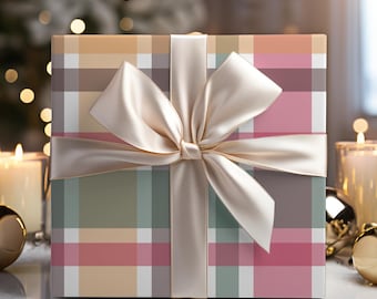 May include: A wrapped gift box with a plaid pattern in shades of pink, beige, green, and white. The box is tied with a cream-colored satin ribbon and bow. The background includes candles, ornaments, and a Christmas tree with bokeh lights.