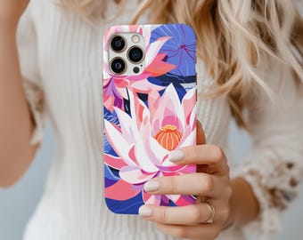 May include: A phone case with a floral design featuring pink and white lotus flowers, blue leaves, and a blue background.