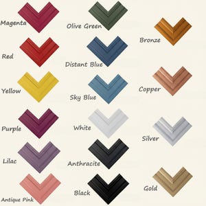 May include: A collection of fifteen V-shaped picture frame corner samples arranged in three columns. Colors include magenta, red, yellow, purple, lilac, antique pink, olive green, distant blue, sky blue, white, anthracite, black, bronze, copper, silver, and gold.
