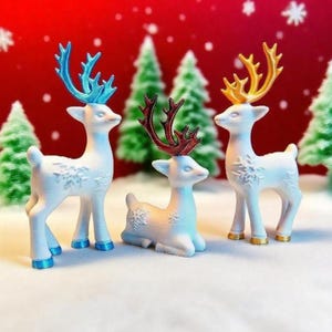 May include: Three white reindeer ornaments with coloured antlers and hooves. One reindeer is lying down, while the other two are standing. The antlers are blue, gold, and red. Snowflake details are on the reindeer's bodies. Christmas decor.