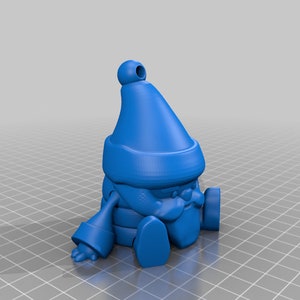 May include: A blue gnome figurine with a pointed hat, scarf, and round nose. The gnome is sitting with its legs extended and arms resting on its knees. The figurine has a small loop at the top of the hat.