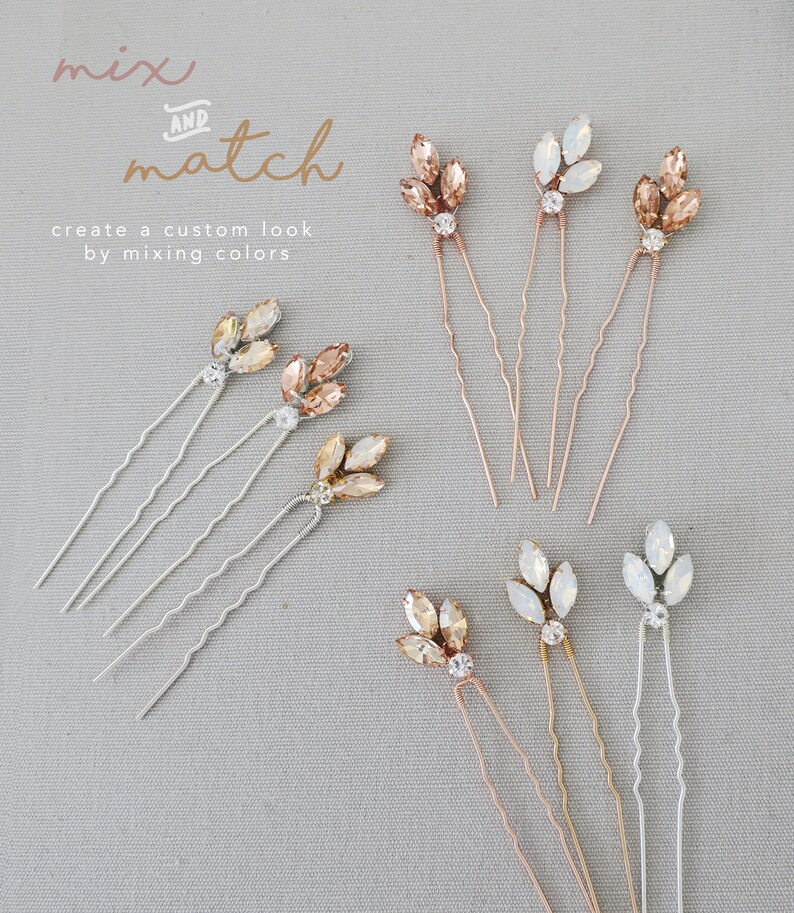 May include: Set of six hair pins with crystal embellishments in three colors: champagne, ivory, and clear. The pins are designed to look like leaves and are perfect for adding a touch of sparkle to any hairstyle.