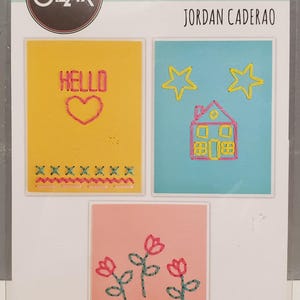May include: Sizzix Thinlits die set featuring three designs: a yellow square with "HELLO" and a heart, a blue square with stars and a house, and a pink square with flowers. Includes 6 dies.