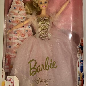 May include: A Barbie doll in a box, dressed as the Sugar Plum Fairy. The doll has blonde hair and wears a pink and gold dress. The box is labeled "Collector Edition" and "First Edition Classic Ballet Series."