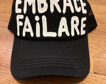 Hand Painted Embrace Failare truckers hat "White on black edition"