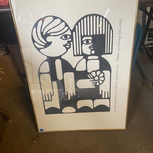 May include: Black and white illustration of two children standing next to each other. The illustration is framed in a gold frame. The text "treten, device them, you with them comes the sun. Children are the kings of the world" is printed below the illustration.