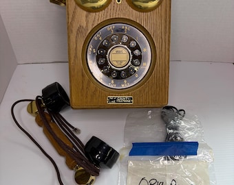 Teléfono de pared antiguo de The Country Store con recibo original.