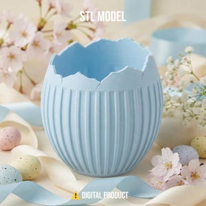 May include: A light blue, egg-shaped container with vertical grooves and a jagged top edge. The words "STL MODEL" and "DIGITAL PRODUCT" are visible. Decorative eggs and ribbons surround the container, suggesting an Easter theme.