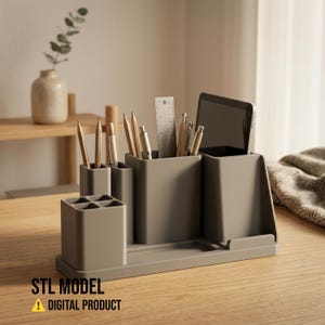 May include: A taupe desk organizer with multiple compartments holding pencils, pens, a ruler, and a tablet. The organizer has a built-in tray and the text "STL MODEL DIGITAL PRODUCT".