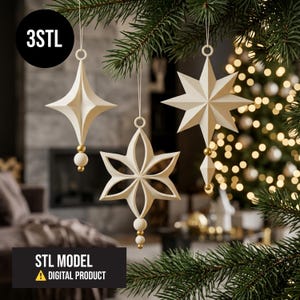 May include: Three off-white geometric hanging ornaments with gold-coloured spherical accents suspended by thin strings. The ornaments feature star and floral-like shapes. Text in the image reads 3STL and STL MODEL DIGITAL PRODUCT.