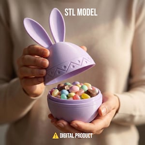 May include: A lilac Easter egg-shaped container with bunny ears, filled with colourful jelly beans. The lid is open, revealing the sweets inside. The text "STL MODEL" and "DIGITAL PRODUCT" are visible.