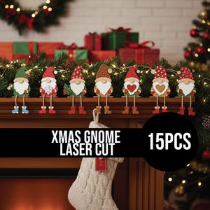 May include: A set of 15 laser-cut Christmas gnome decorations. Each gnome features a white beard, a colourful hat, and dangling legs. The gnomes are displayed on a wooden surface with Christmas greenery and lights.