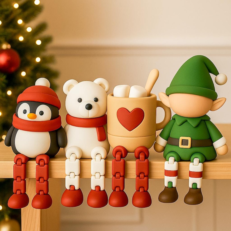May include: A whimsical Christmas-themed display featuring a penguin, polar bear, a mug of hot chocolate, and an elf. The figures have articulated legs and are dressed in festive attire. The penguin wears a red hat and scarf, the bear a red scarf, and the elf a green outfit.