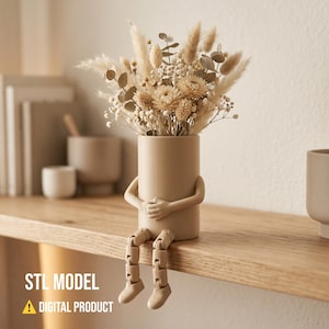 May include: A beige vase with arms and articulated legs, holding a bouquet of dried flowers. The vase is sitting on a wooden shelf. The text "STL MODEL" and "DIGITAL PRODUCT" are visible.