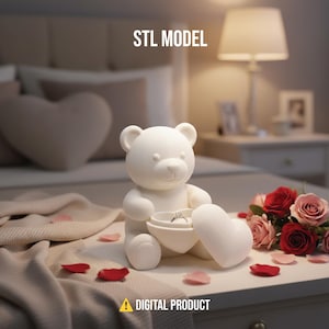 May include: A white teddy bear ornament holding a heart-shaped box containing a ring. The bear is on a white surface with rose petals and a bouquet of red and pink roses. The text "STL MODEL" and "DIGITAL PRODUCT" are visible.