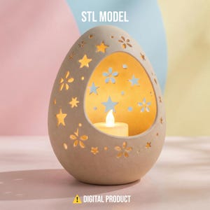 May include: A beige, egg-shaped candle holder with star and flower cutouts. The interior glows with a warm light from a small candle. The text "STL MODEL" and "DIGITAL PRODUCT" are visible.